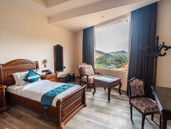 an image of a bedroom with mountain views